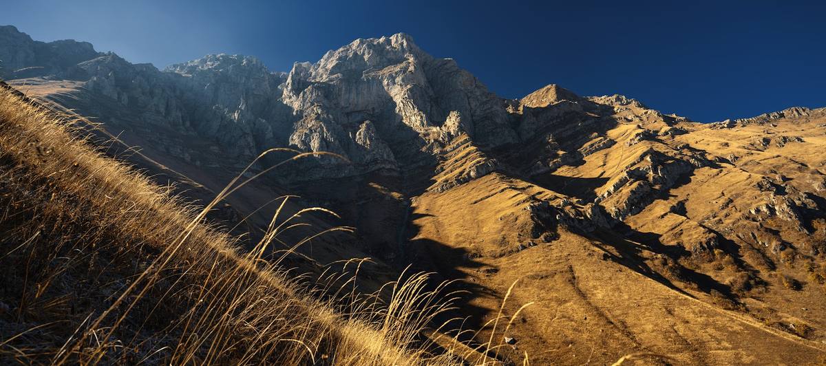 A path across a rocky slope at golden hour