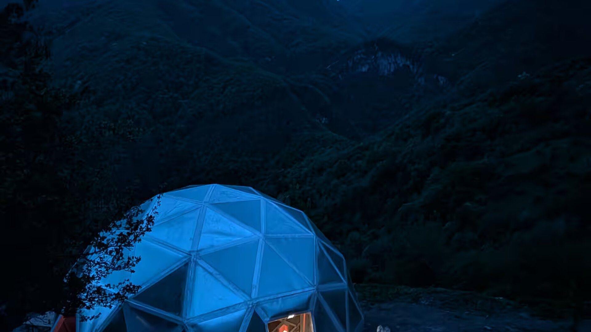 The K7 geodesic dome glowing at dusk on the slopes of Mount Khustup